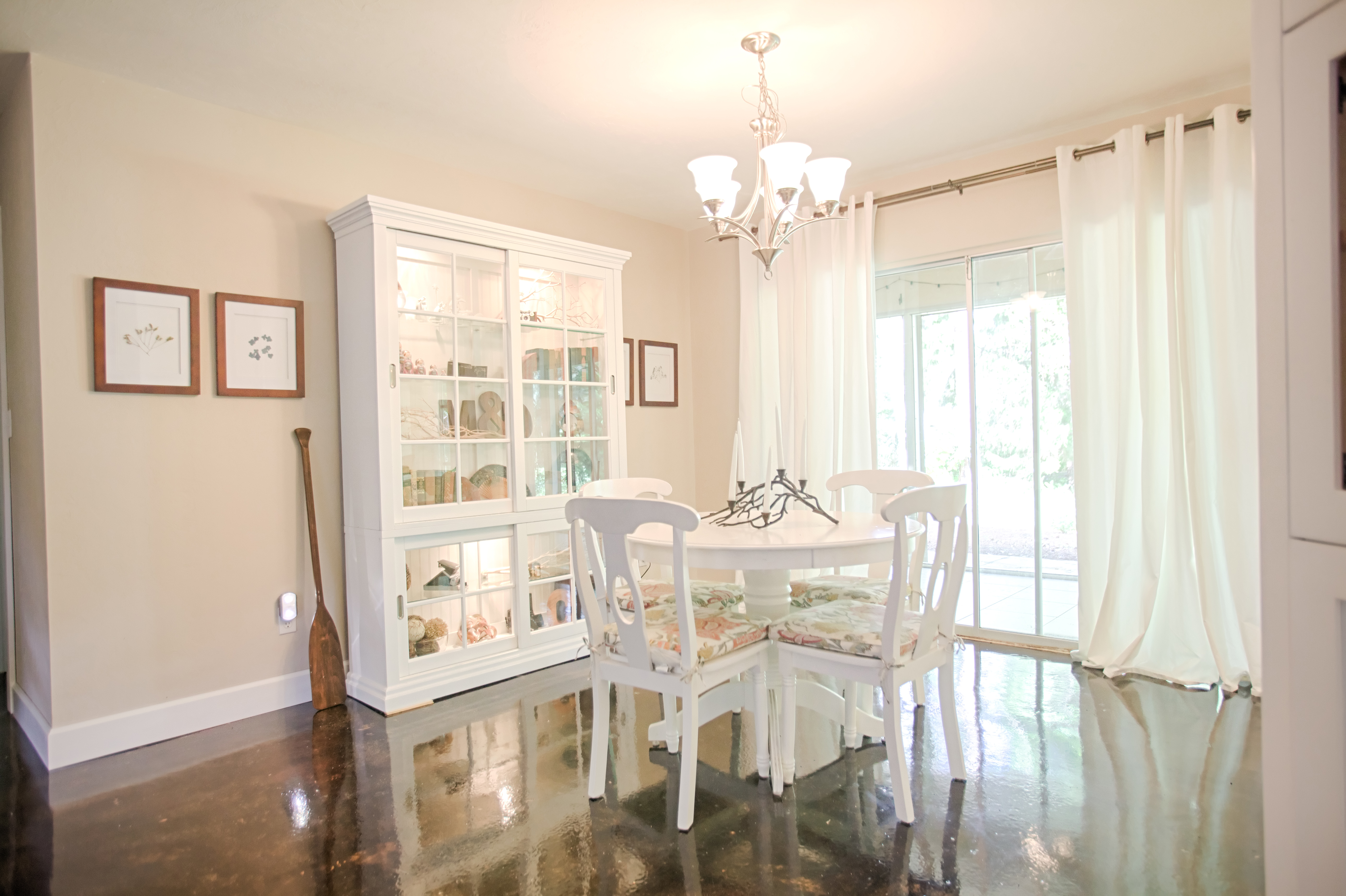 The dining room, painted Benjamin Moore's Cedar Key, is decorated with secondhand furniture